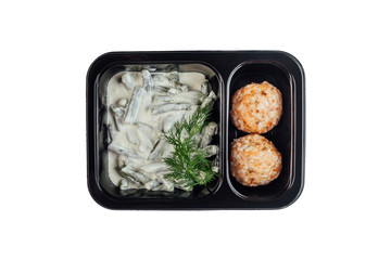 Healthy lunch at workplace. Take away meals in black containers with cutlery on gray table