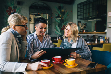 women in restaurant looking at the menu