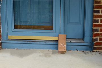 Shipping box on a porch propped up against the front door