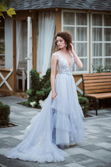 Obraz premium Young bride wearing wedding dress and posing outside