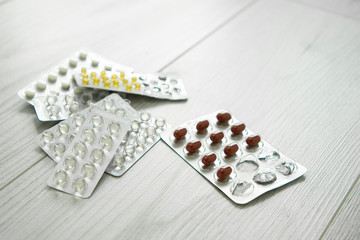 packs of different pills lie on a white background