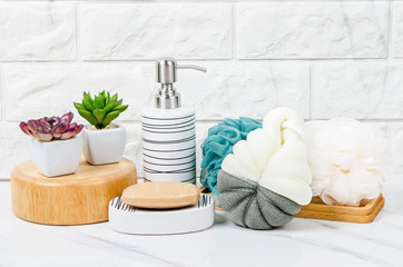 Herb soap, shower sponge inside a bright bathroom background.