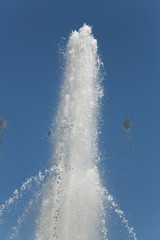 Fountain water jets against clear blue sky