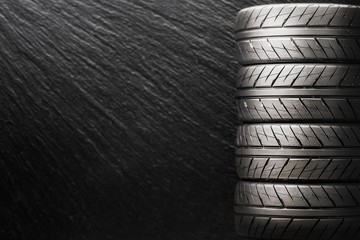 sports tires with a beautiful directional pattern on a dark background. copy space , text space, concept layout
