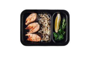 Healthy lunch at workplace. Take away meals in black containers with cutlery on gray table
