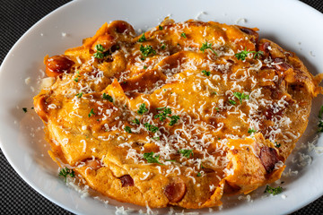 Omelette with pork sausages, onion and gratted parmegiano