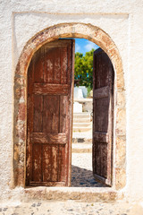 Old wooden door of the house. Traditional greek architecture on Santorini island, Greece.