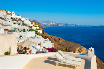 Fototapeta na wymiar White architecture and blue sea on Santorini island, Greece. Beautiful terrace with sea view.
