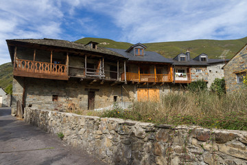 Fototapeta na wymiar Old rural stone buildings, slate roofs and wooden balconies 