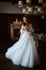 Fototapeta premium portrait of Stunning young fashionable bride holding bouquet