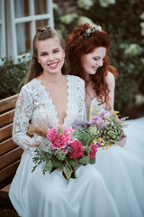 Portrait of two young happy smiling brides