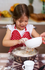Young girl cooking a pastry