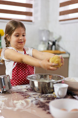 Young girl cooking a pastry