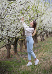 Beautiful girl in a flowered garden