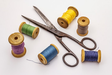 Old vintage scissors and spools of thread isolated on white background. Tool for sewing, handmade,...