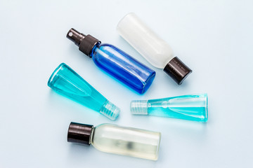 Sanitizer spray and gel isolated on blue background