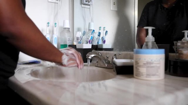 Black woman washing hands