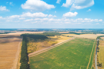 Summer rural landscape, view from above. Landscape of plowed fields, green fields, and road with beautiful sky