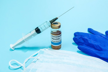 A test vaccine for coronavirus. A vial with a Vaccine from Covid-2019 on a blue background. A cure...
