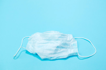 Protective medical mask, medical gloves and a sanitizer on a blue background. The first necessary protection for coronavirus. Covid-2019. Pandemic 2020.