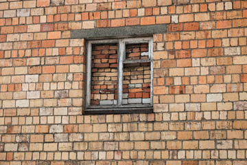 Fototapeta na wymiar Bricked up window on a brick wall. Isolated house
