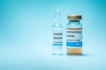 A test vaccine for coronavirus. A vial with a Vaccine from Covid-2019 on a blue background. A cure...