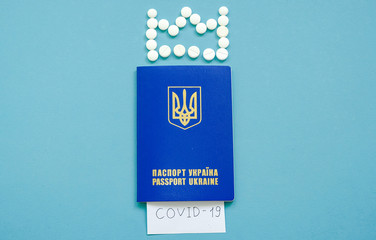 Ukrainian passport with the inscription Covid-19 and a crown of tablets