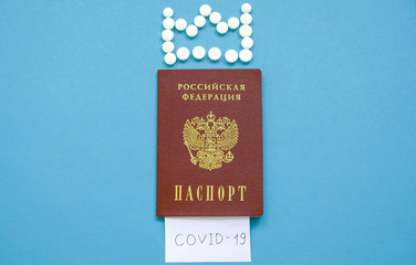 Russian passport with the inscription Covid-19 and a crown of tablets