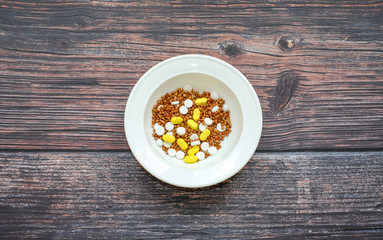 Buckwheat in a white plate mixed with tablets
