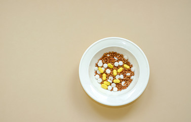 Buckwheat in a white plate mixed with tablets
