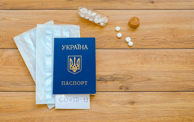 Ukrainian passport with the inscription Covid-19, Protective masks and tablets