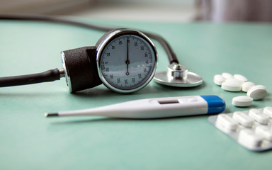  Medications - pills and thermometer. stethoscope, spray, vitamins, a bottle lying on a blue background. Pharmacy Shopping.