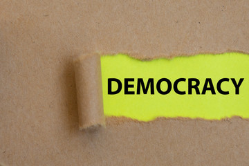 Democracy, word written under torn paper Image.
