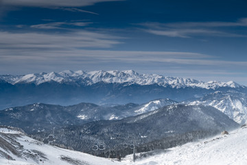 Naklejka premium The famous snowed mountain of Parnassos with popular ski resort covered up in snow and unique nature, cable cabins, car parking, Voiotia, Greece