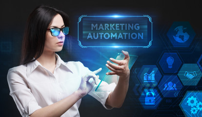 Business, Technology, Internet and network concept. Young businessman working on a virtual screen of the future and sees the inscription: Marketing automation