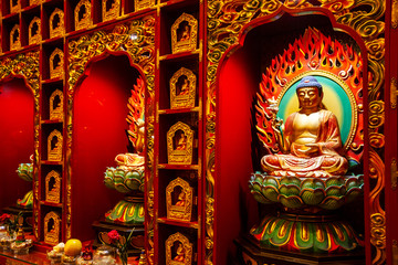 Fototapeta premium Close-up on a Buddha statue inside the Buddha Tooth Relic Temple in Chinatown District, Singapore.