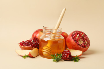 Apple, honey and pomegranate on beige background. Home treatment