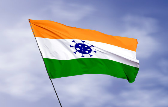 India flag flying in wind with Coronavirus (covid-19) virus icon
