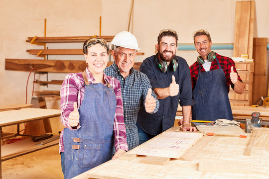 Successful craftsman team with trainee - Powered by Adobe