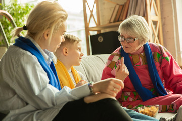 Excited family watching football, sport match at home. Grandma, mother and son cheering for national basketball, football, tennis, soccer, hockey team. Concept of emotions, support, cheering.