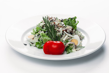 salad with egg on a plate on a white background