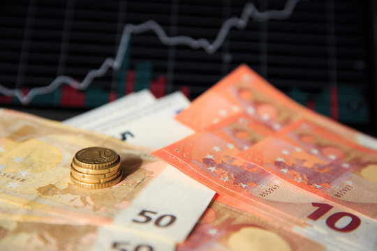 Euro coins and banknotes crisis stock market graph business forex trading and analysis investment indicator of financial board display  exchange growth and digital background. Concept exchange money. 