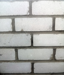 brick wall. Gray background. White brick