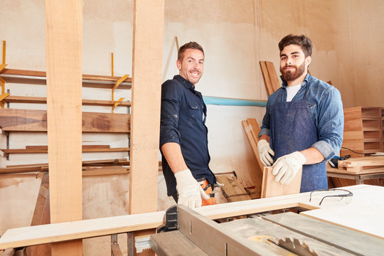 Two young men as carpenters apprentices