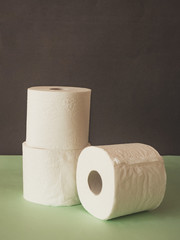 Still life of toilet paper on green and black background