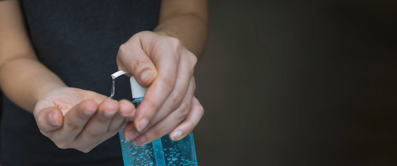 Close up woman's hand pressing alcohol gel from bottle, apply sanitizer gel for hand wash to make clean and clear germ, bacteria, and virus. Pandemic protection and Hygienic concept, selective focus