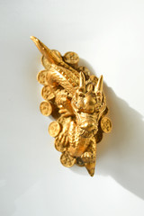 Golden dragon. a figurine of a mythical animal.