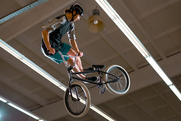 Young BMX Rider Doing Extreme Tricks on Bike in the Skatepark. Healthy and Active Lifestyle.