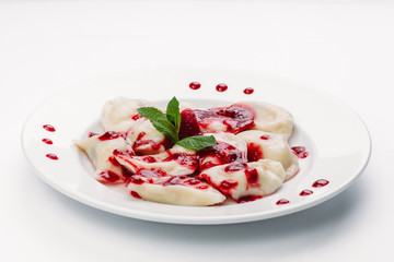 dumplings with red sauce on a white plate