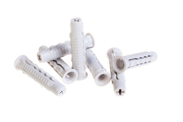 Many plastic dowels, isolated on white. Screw anchor, construction tools